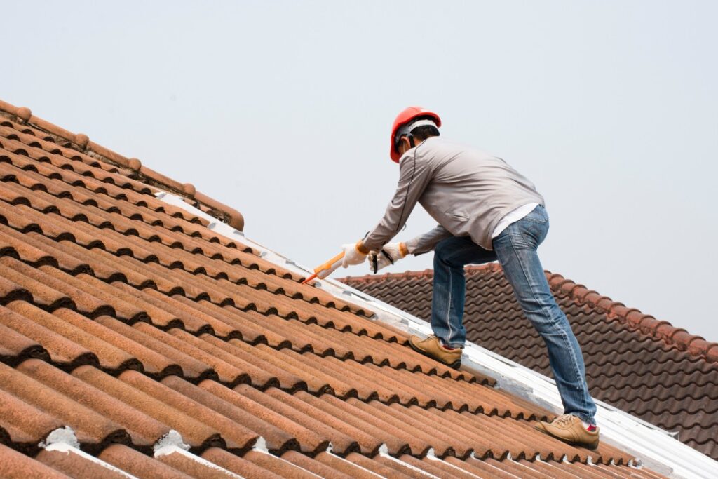 Roof repair man at work.