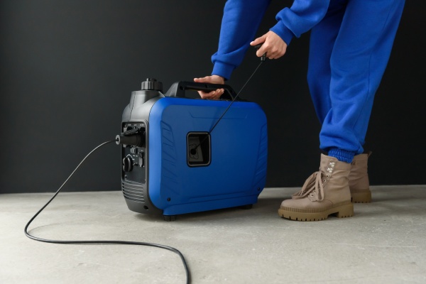 A,Woman,In,A,Blue,Suit,Starts,A,Generator.,A