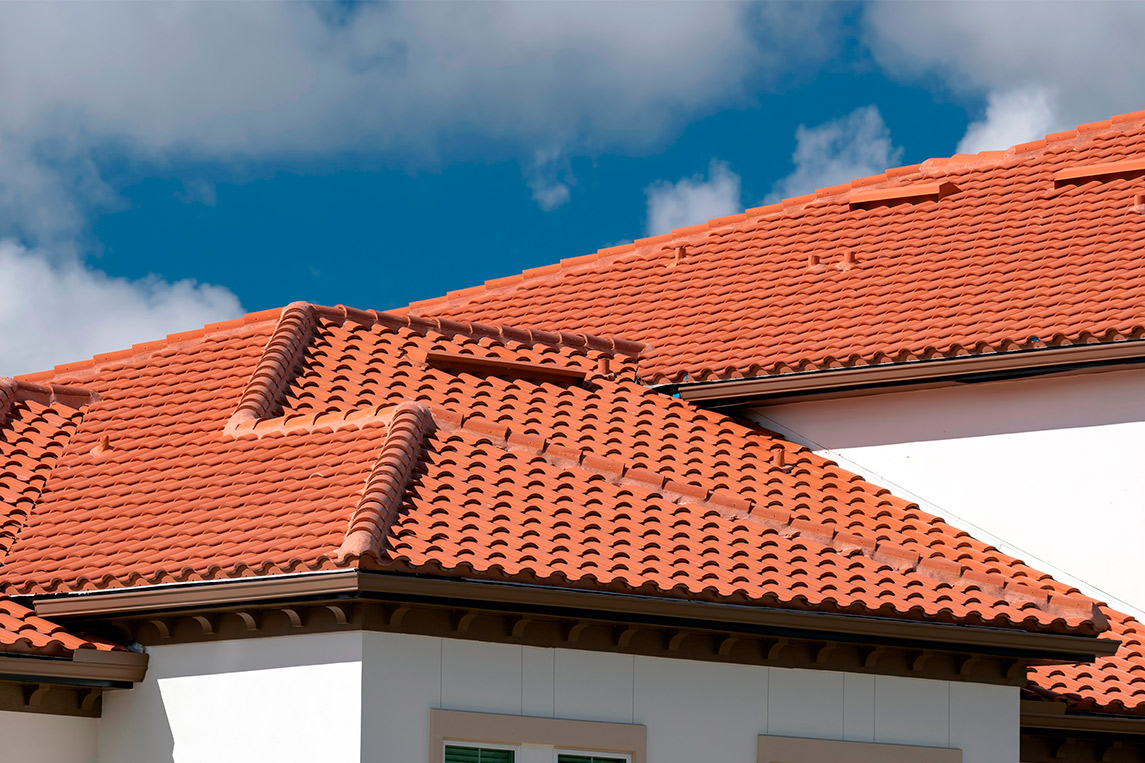 A red clay tile roof atop a house, showcasing the architectural features relevant to Edinburg's historic homes repair guide.